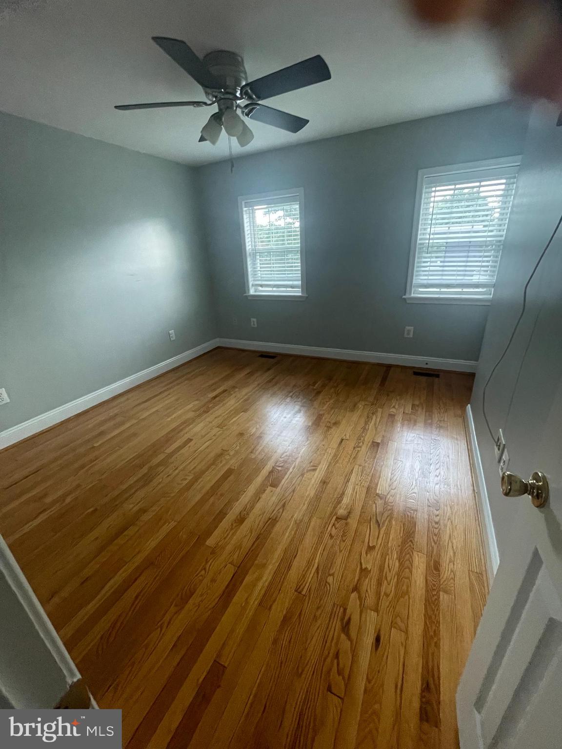 2002 E Street Northeast Washington, DC 20002 - Photo 7 of 13 an empty room with wooden floor and windows