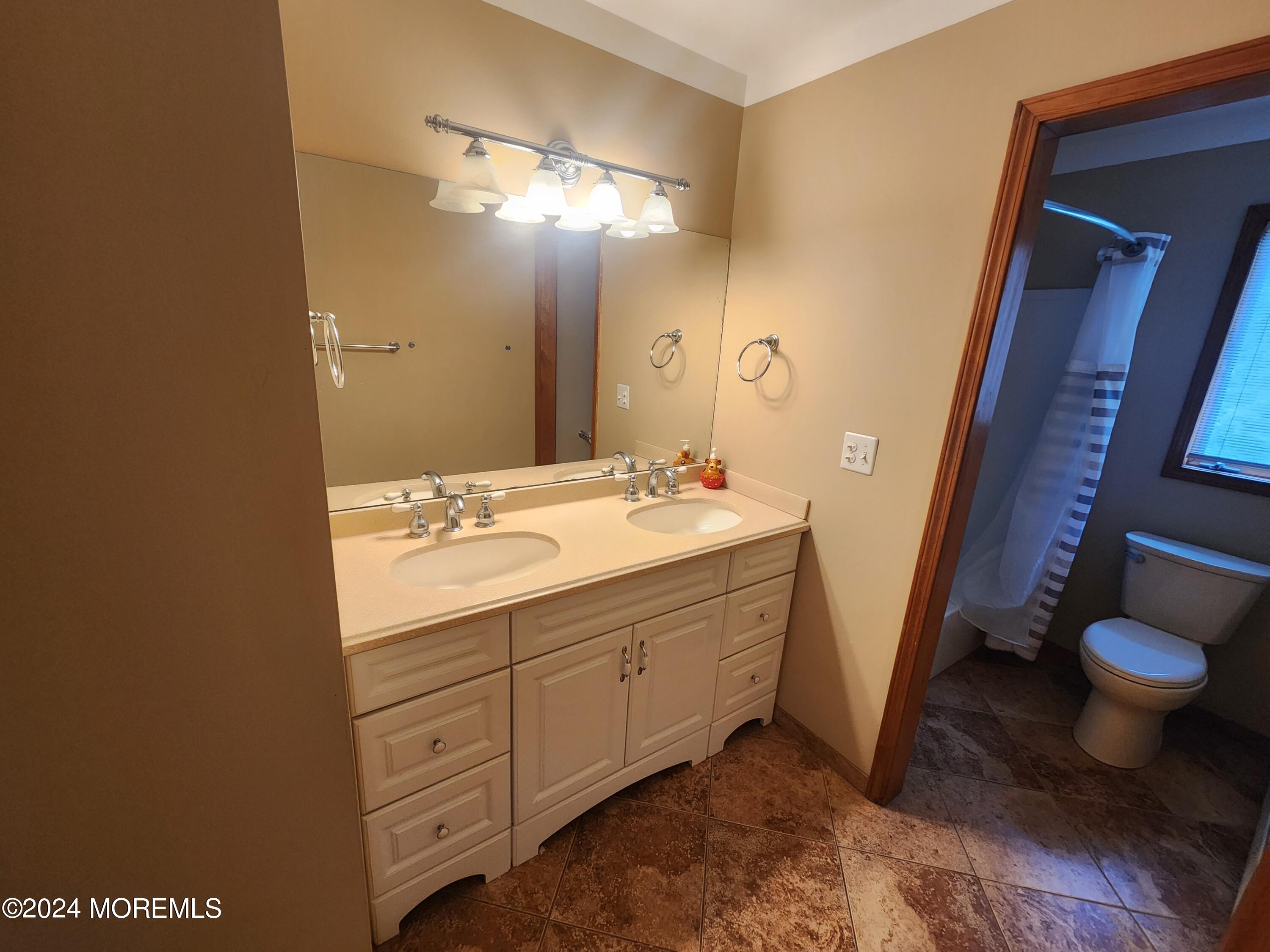 1850 Lakeside Drive South Forked River, NJ 08731 - Photo 23 of 54 a bathroom with a sink a toilet and a mirror