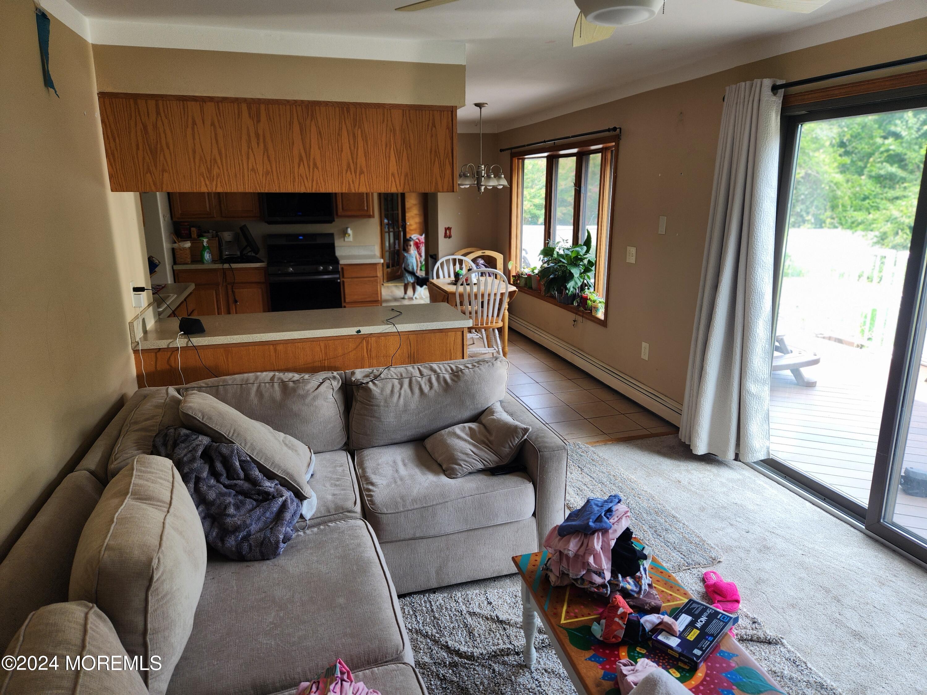 1850 Lakeside Drive South Forked River, NJ 08731 - Photo 25 of 54 a living room with furniture fireplace and flat screen tv