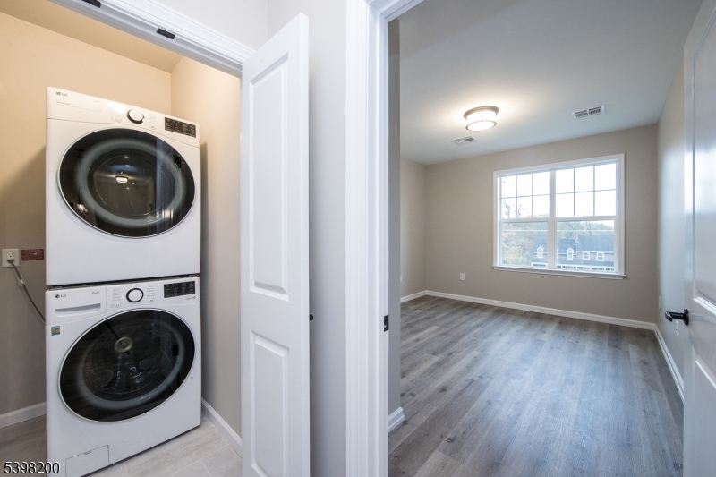 2435 Lamington Road, Unit 18 Bedminster, NJ 07921 - Photo 11 of 13 a view of a hallway with washer and dryer
