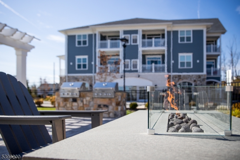 2435 Lamington Road, Unit 18 Bedminster, NJ 07921 - Photo 2 of 13 a view of dinning table and chairs in patio