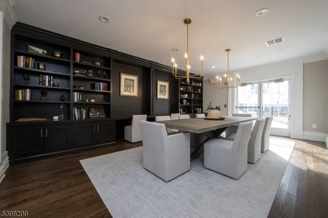 a large kitchen with kitchen island a sink a table and chairs