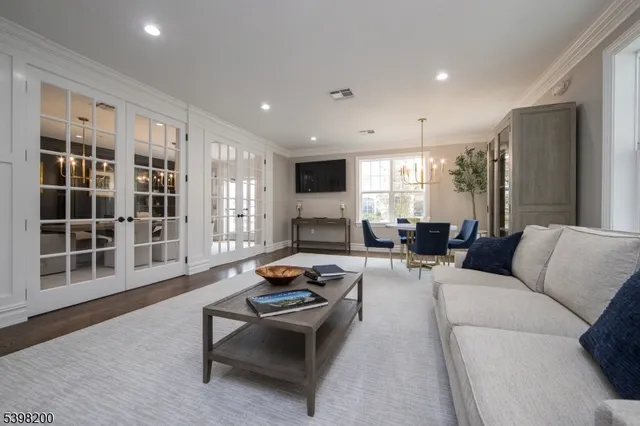 a living room with furniture window and a wooden floor