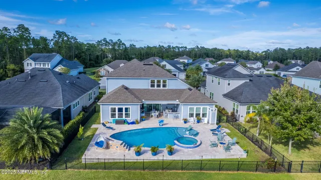 a view of a swimming pool patio and outdoor seating