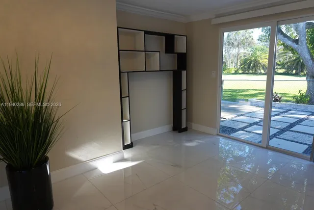 a view of empty room with floor to ceiling window