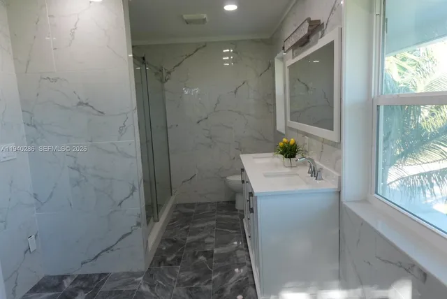 a bathroom with a sink a mirror and a shower