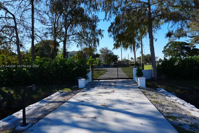 a view of house with backyard and garden