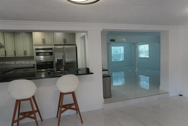 a bathroom with a granite countertop sink a toilet and mirror