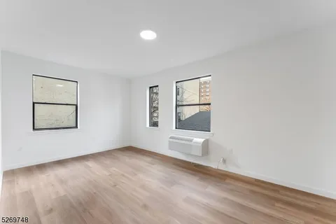 a view of a room with wooden floor