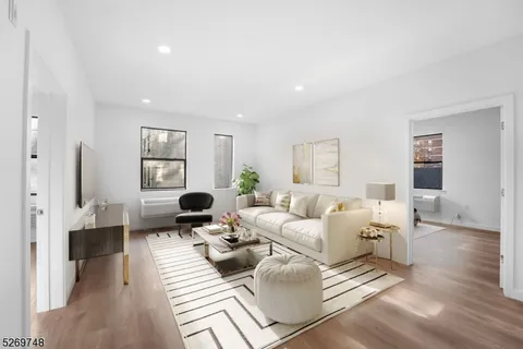 a living room with furniture window and wooden floor