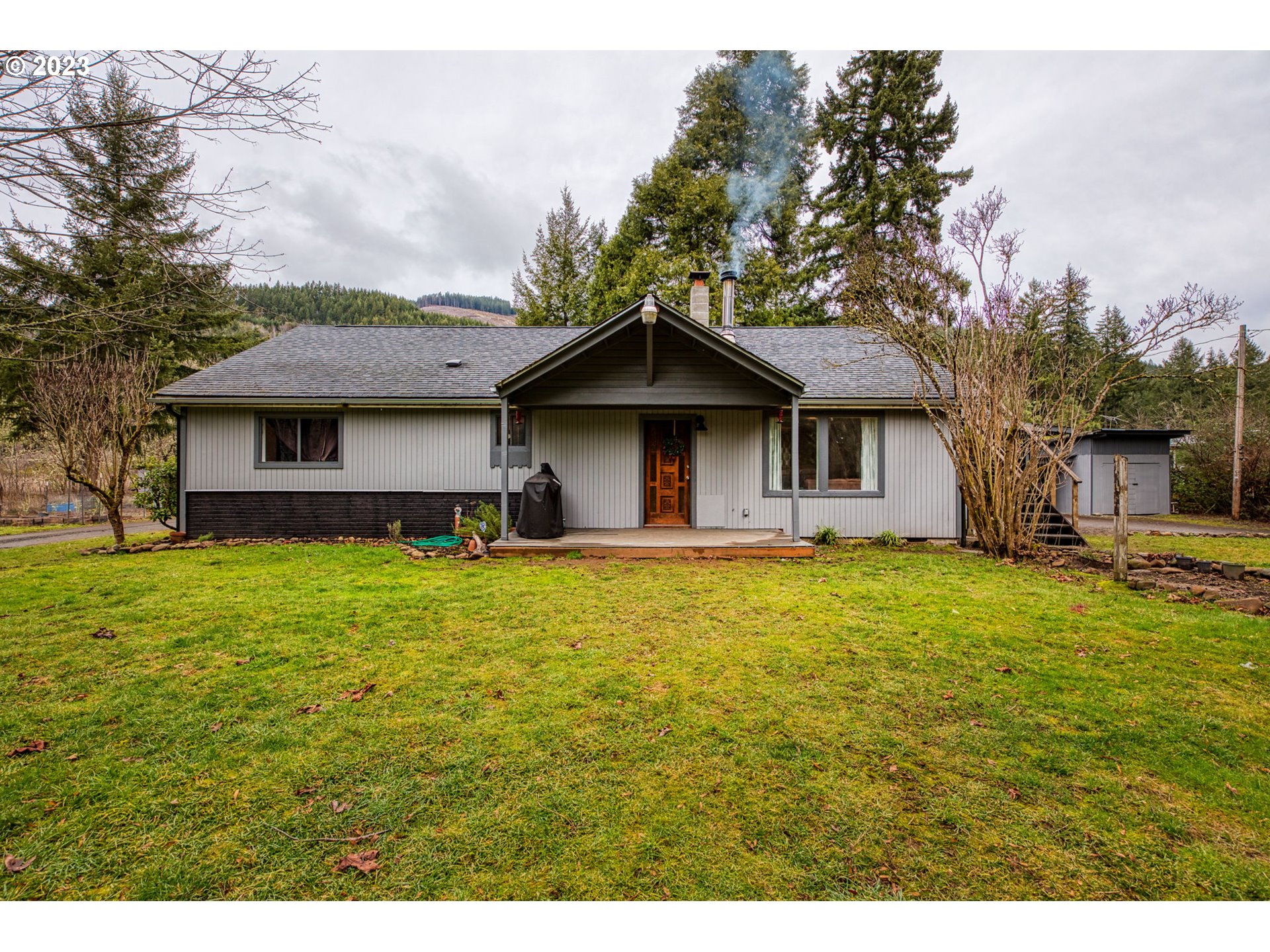38211 Row River Road Dorena, OR 97434 - Photo 1 of 32 a front view of a house with a garden