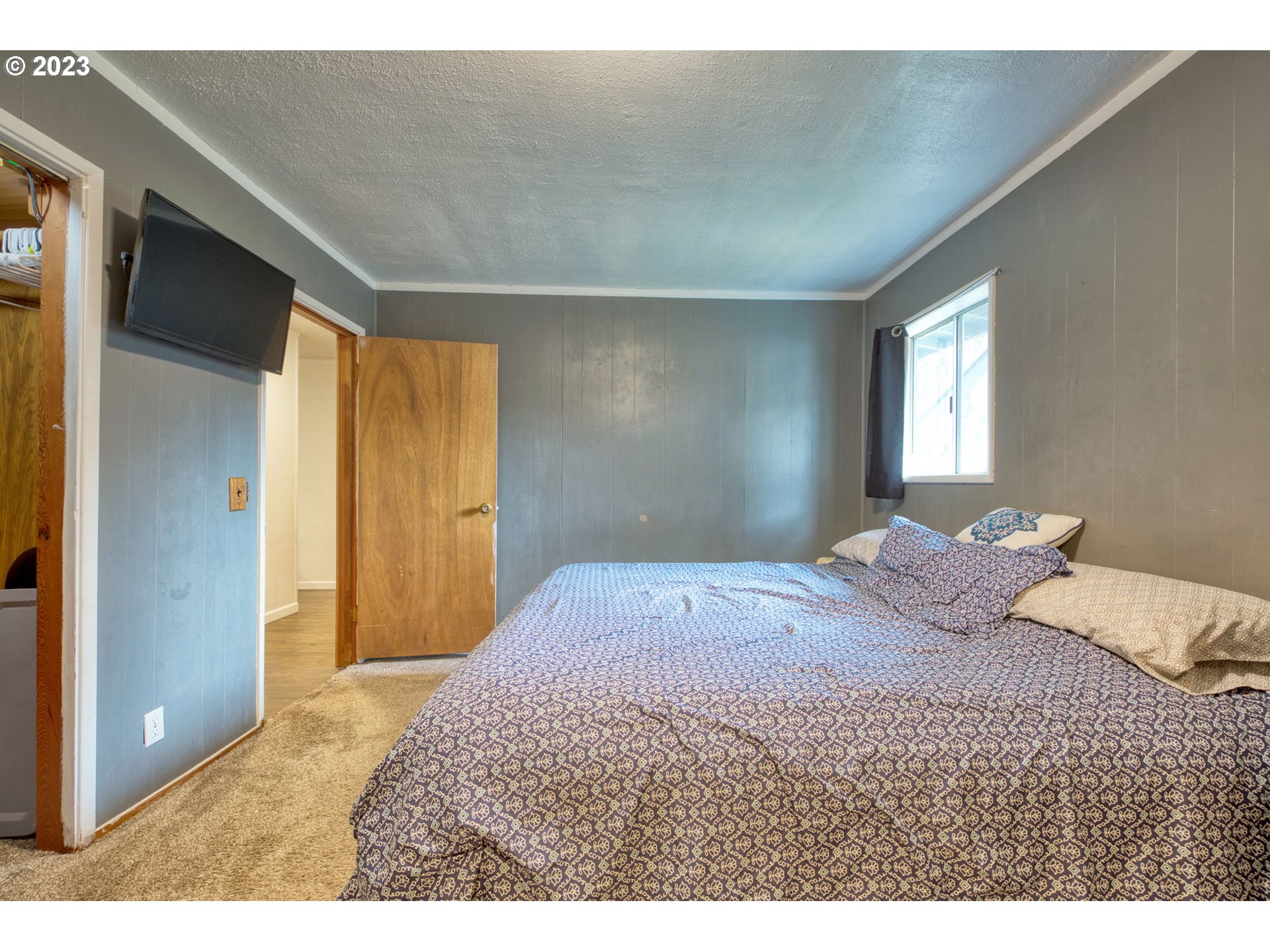 38211 Row River Road Dorena, OR 97434 - Photo 11 of 32 a bedroom with a bed and a walk in closet