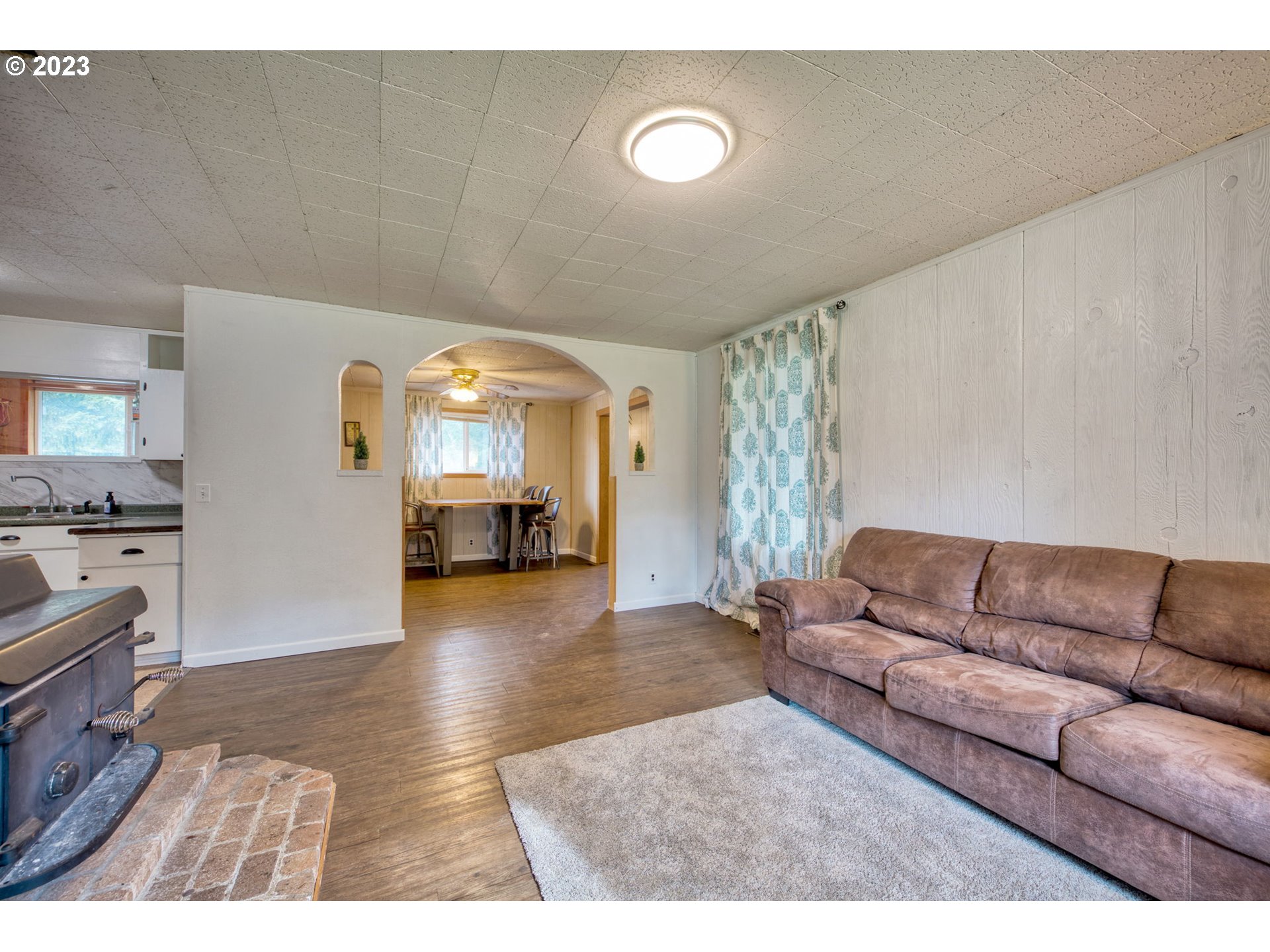 38211 Row River Road Dorena, OR 97434 - Photo 7 of 32 a living room with furniture and a flat screen tv