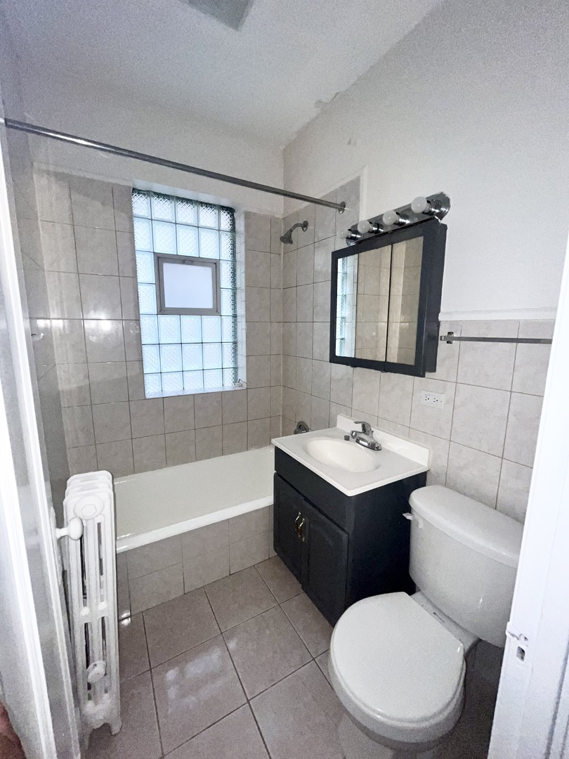 2140 North Kildare Avenue, Unit 2 Chicago, IL 60639 - Photo 11 of 11 a bathroom with a sink a toilet and shower