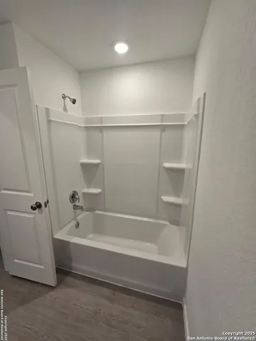 a spacious bathroom with a bathtub and a shower