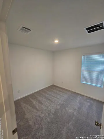 an empty room with a empty space and windows