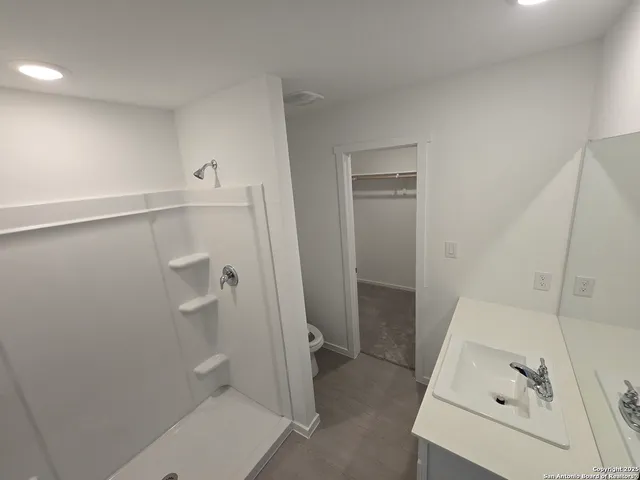 a bathroom with a sink and shower