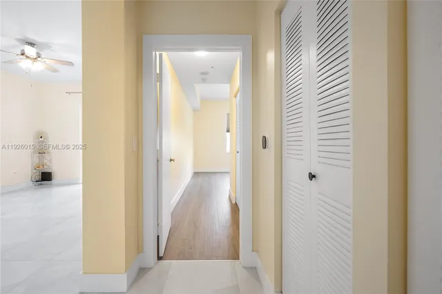 a view of a hallway with wooden floor