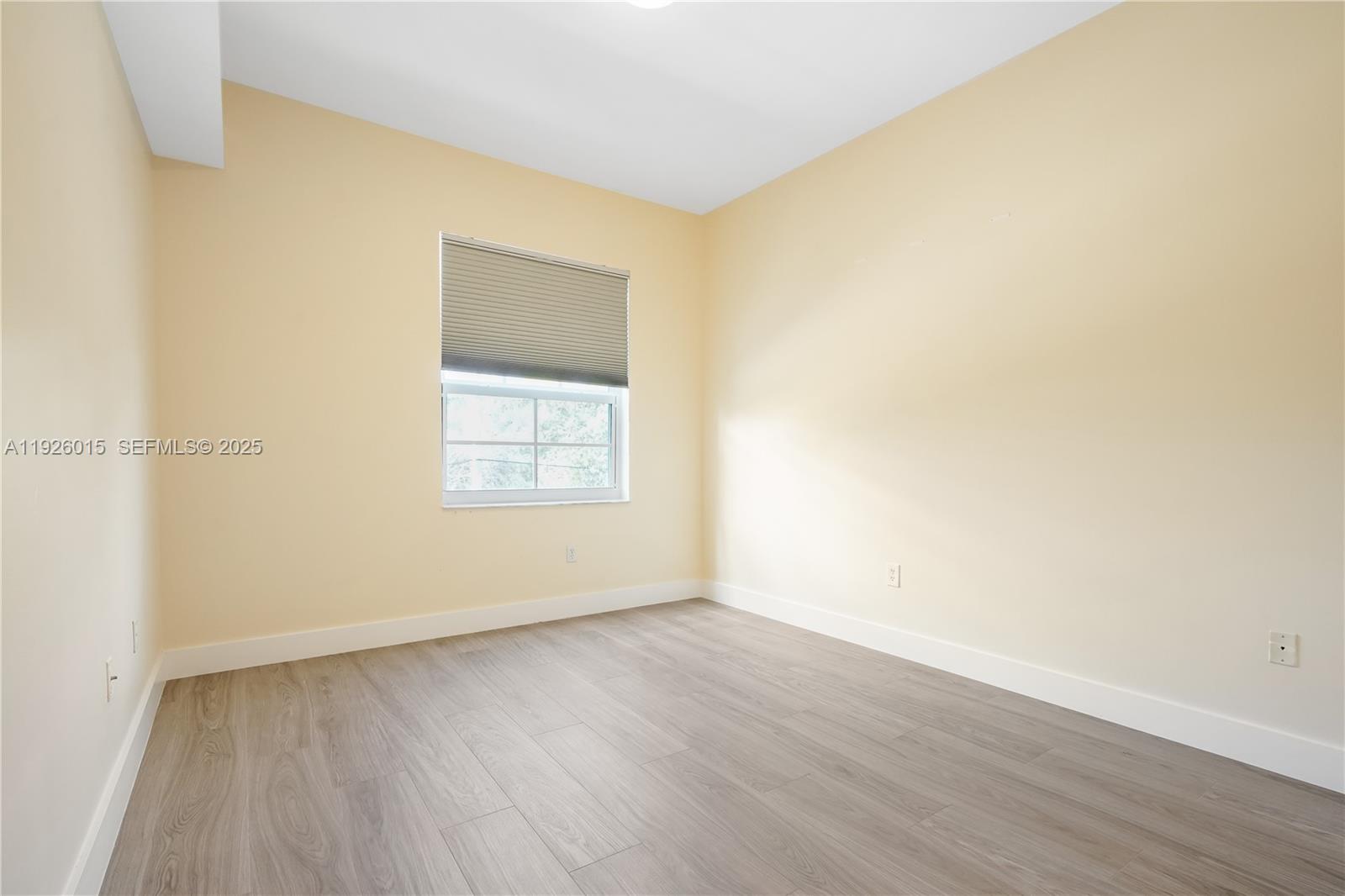 520 Southeast 5th Avenue, Unit 1109 Fort Lauderdale, FL 33301 - Photo 24 of 39 an empty room with wooden floor and windows