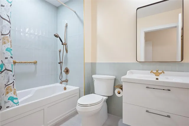 a kitchen with stainless steel appliances granite countertop a refrigerator a stove and a sink