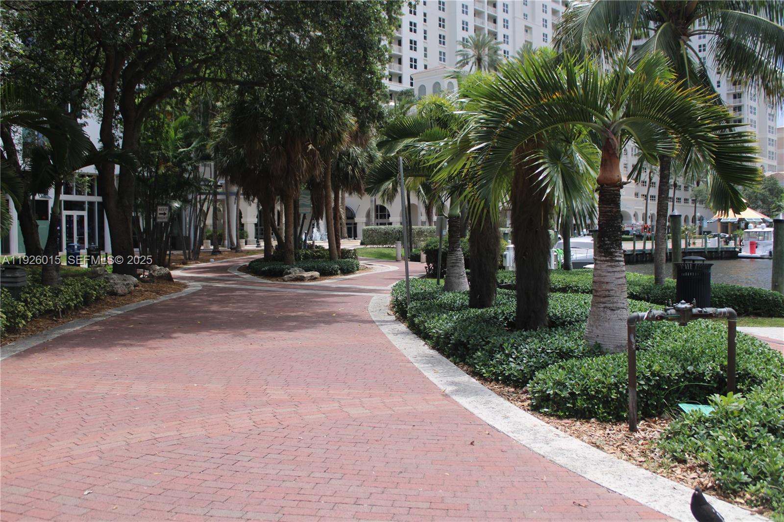520 Southeast 5th Avenue, Unit 1109 Fort Lauderdale, FL 33301 - Photo 37 of 39 a pathway of a house with a yard and palm trees