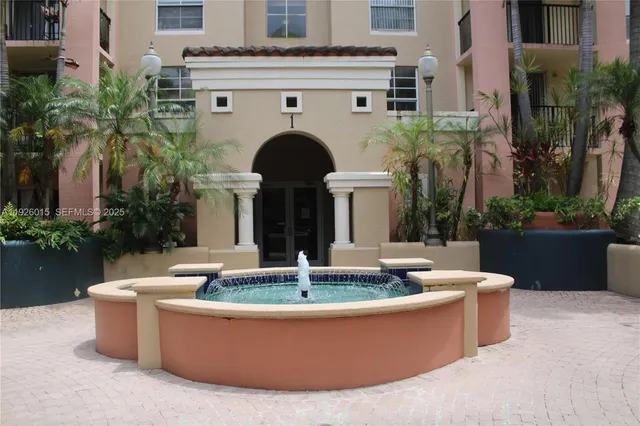 a view of a house with fountain in a patio