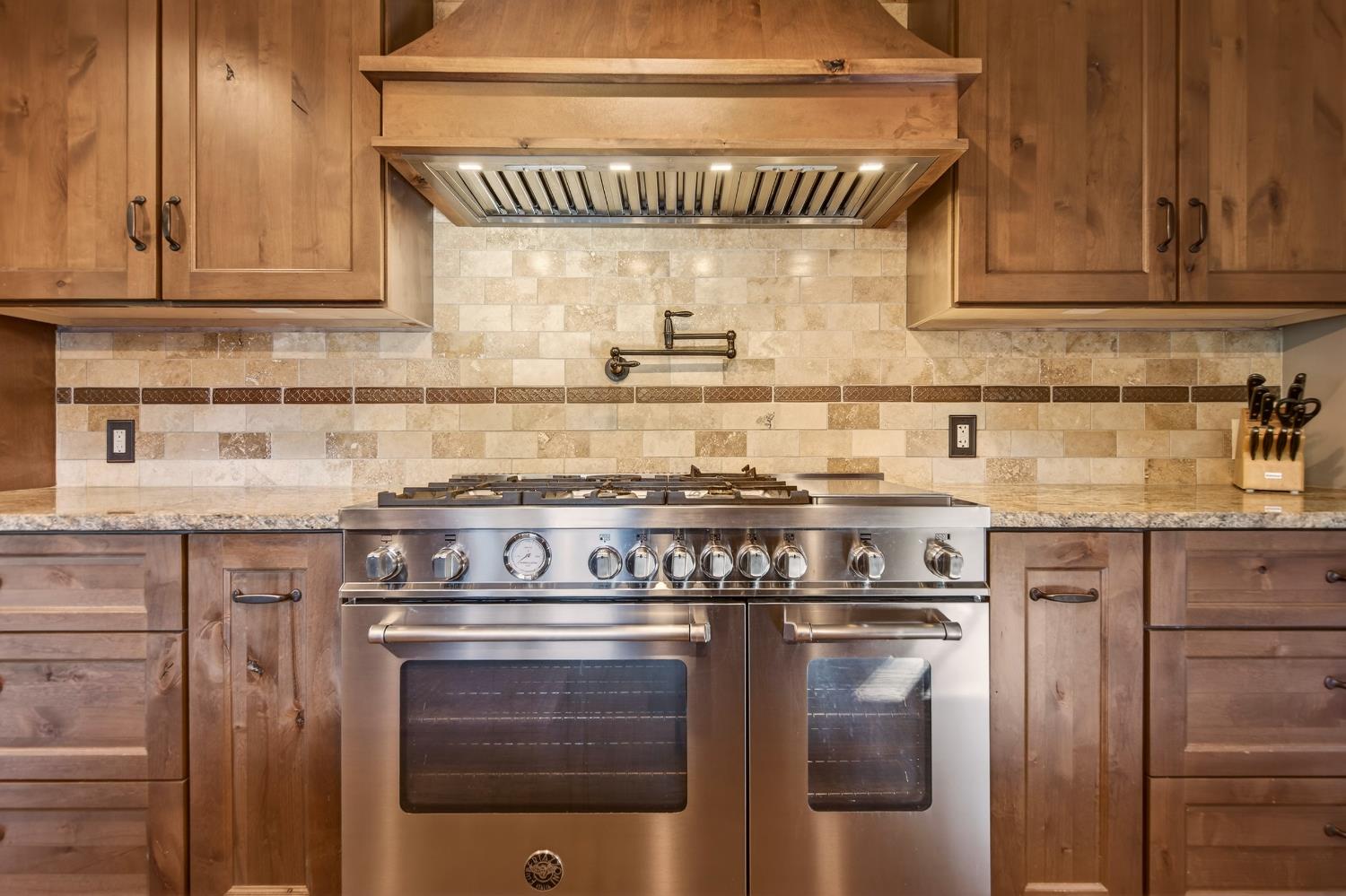 11234 Valencia Road Nevada City, CA 95959 - Photo 14 of 62 a kitchen with stainless steel appliances granite countertop a stove and a cabinets