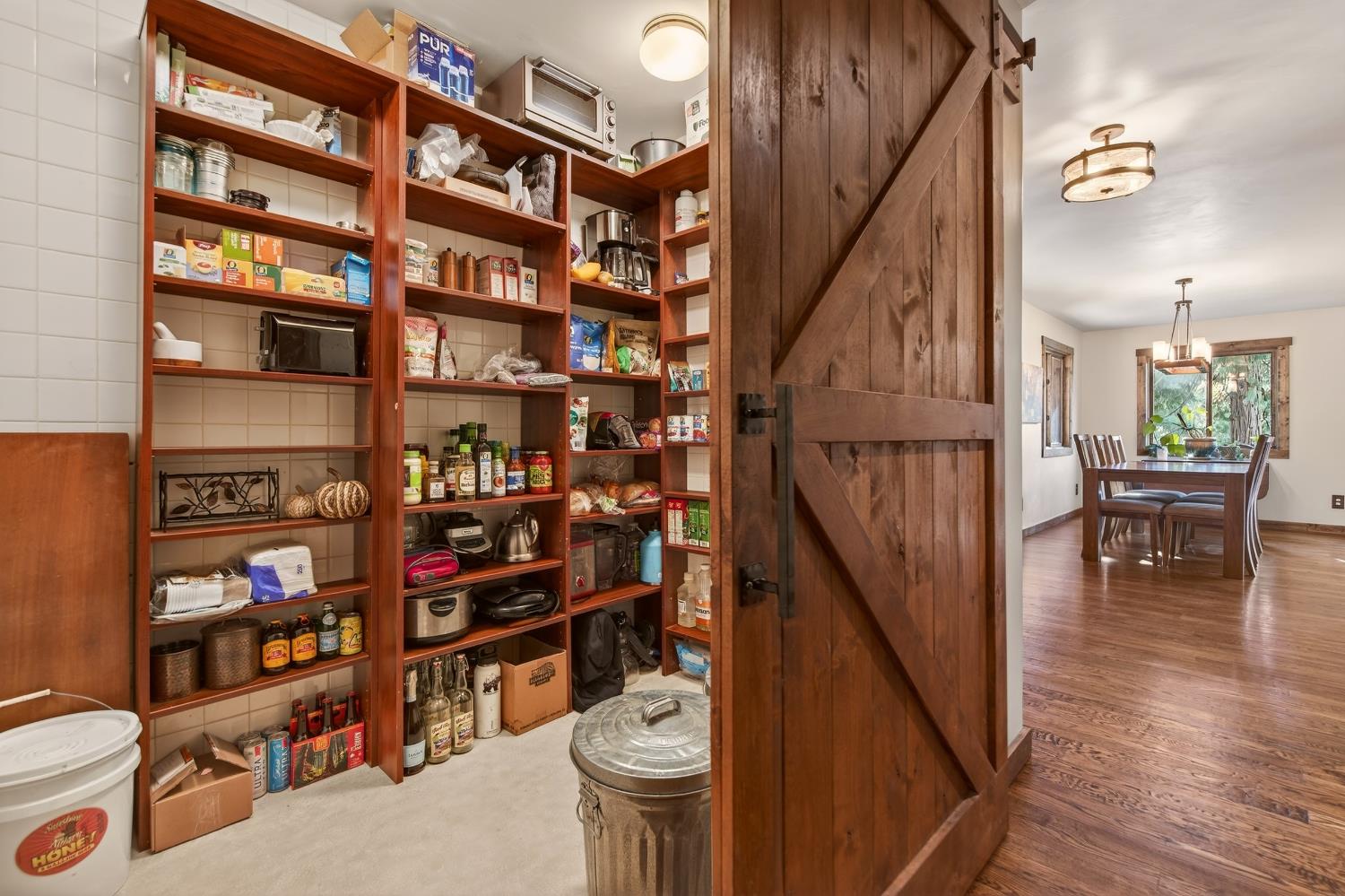 11234 Valencia Road Nevada City, CA 95959 - Photo 19 of 62 a view of a hallway with wooden floor and a book shelf