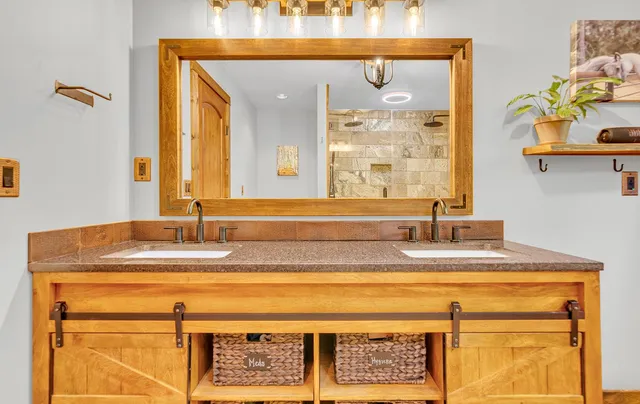 a bathroom with a granite countertop sink and a mirror