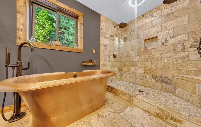 a bathroom with a bathtub and shower