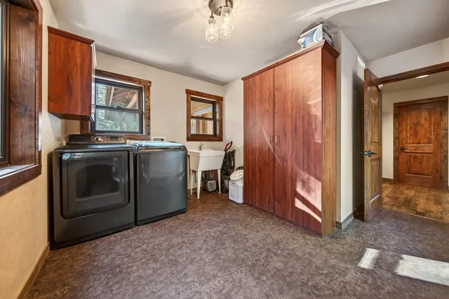 a view of a hallway with wooden floor and stairs