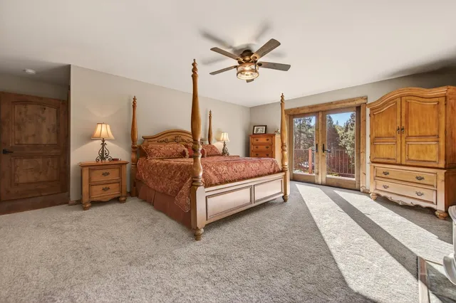 a bedroom with furniture and a large window