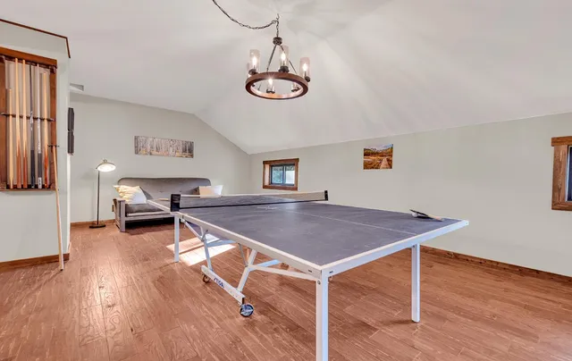 a view of a room with wooden floor windows and cabinet