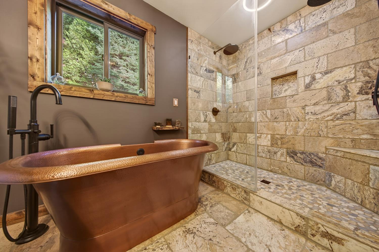 11234 Valencia Road Nevada City, CA 95959 - Photo 29 of 62 a bath tub sitting next to a blue sink and a shower