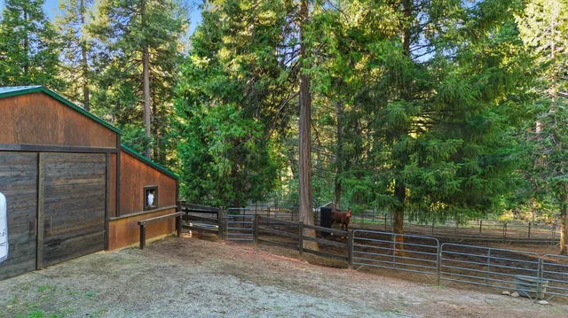 a backyard of a house with wooden floor and fence