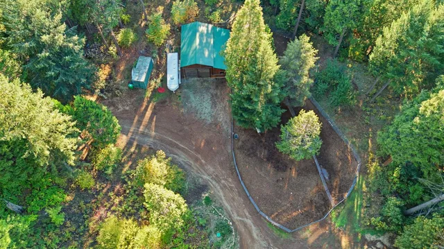 an aerial view of a house with a yard