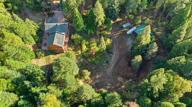 an aerial view of a house with a yard and garden