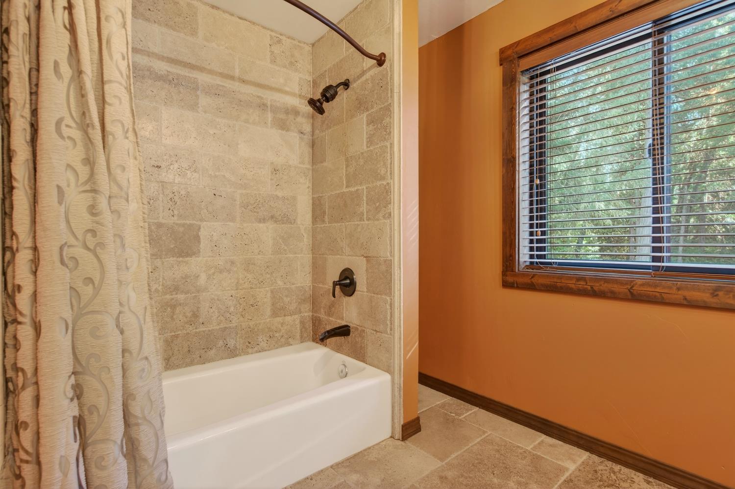 11234 Valencia Road Nevada City, CA 95959 - Photo 47 of 62 a bathroom with a bathtub and a shower