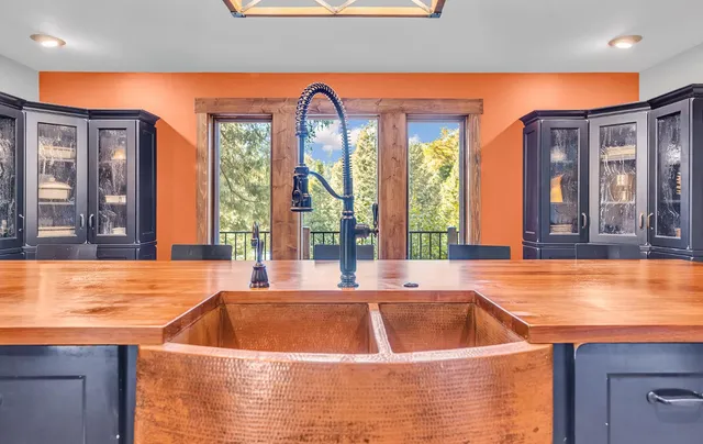 a view of an outdoor kitchen with swimming pool and furniture
