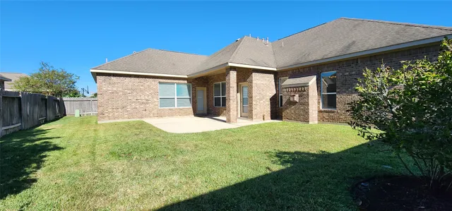 a backyard of a house with garden and plants