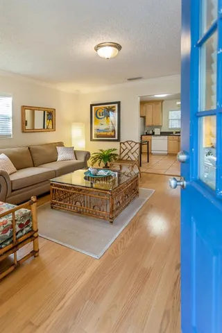 a living room with furniture and a wooden floor