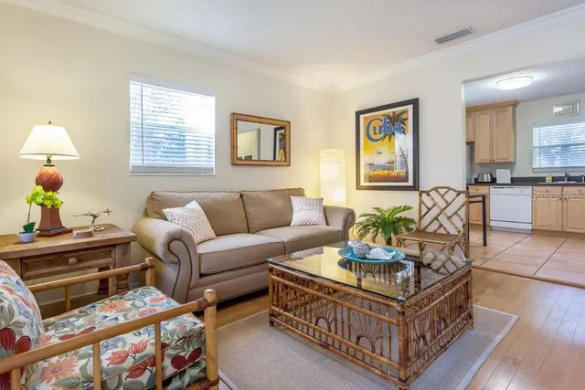 a living room with furniture a dining table and a window