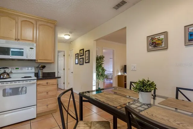 a view of a dining room with furniture and a potted plant