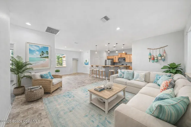 a living room with furniture and a potted plant
