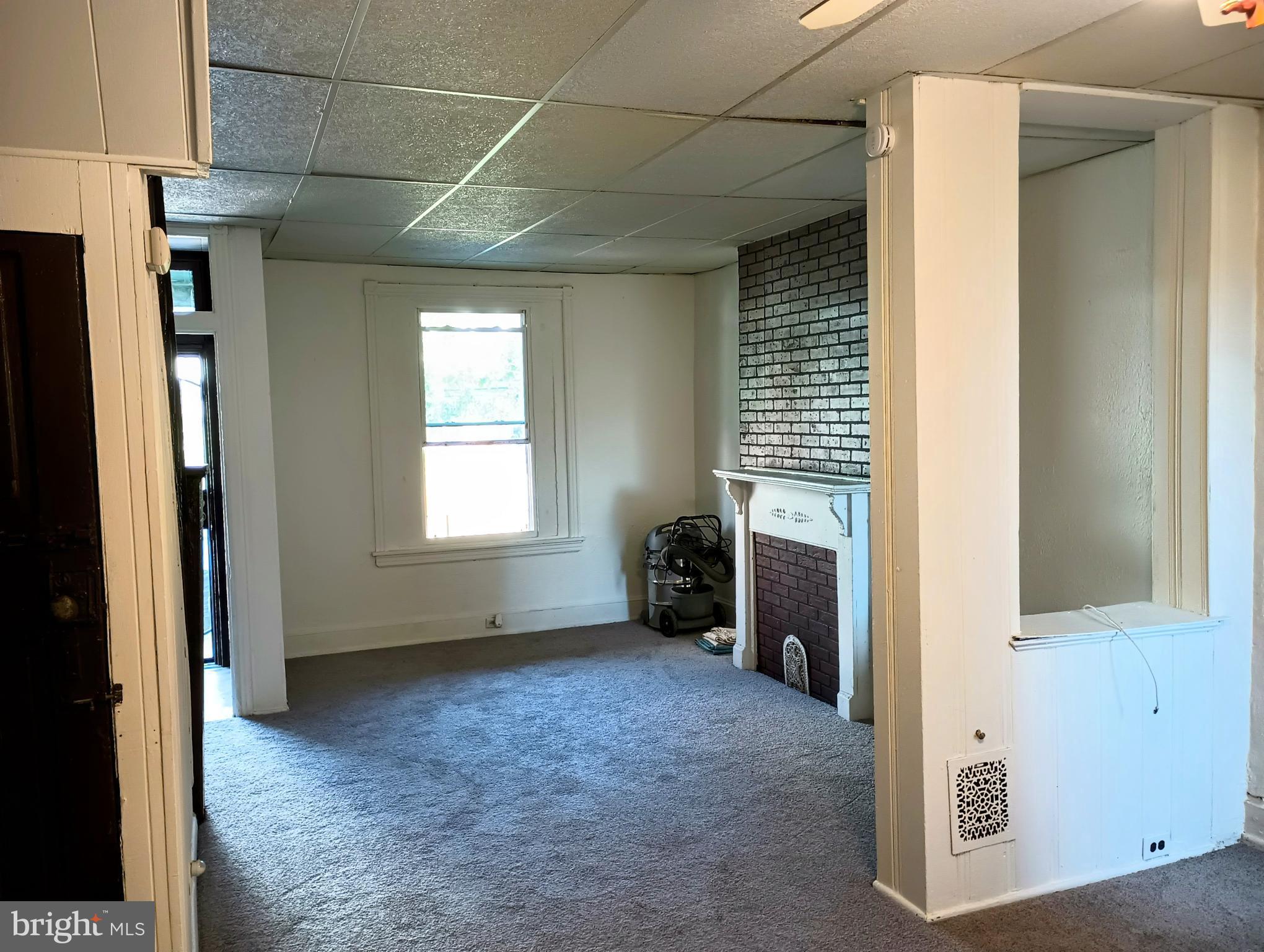 5140 Ranstead Street Philadelphia, PA 19139 - Photo 11 of 24 a view of an empty room with a fireplace and a window
