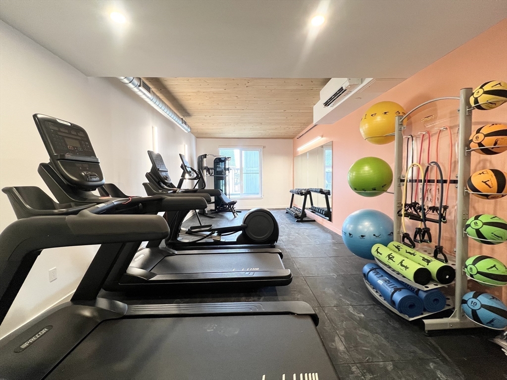154 Broadway, Unit 409 Somerville, MA 02145 - Photo 13 of 18 a room with gym equipment