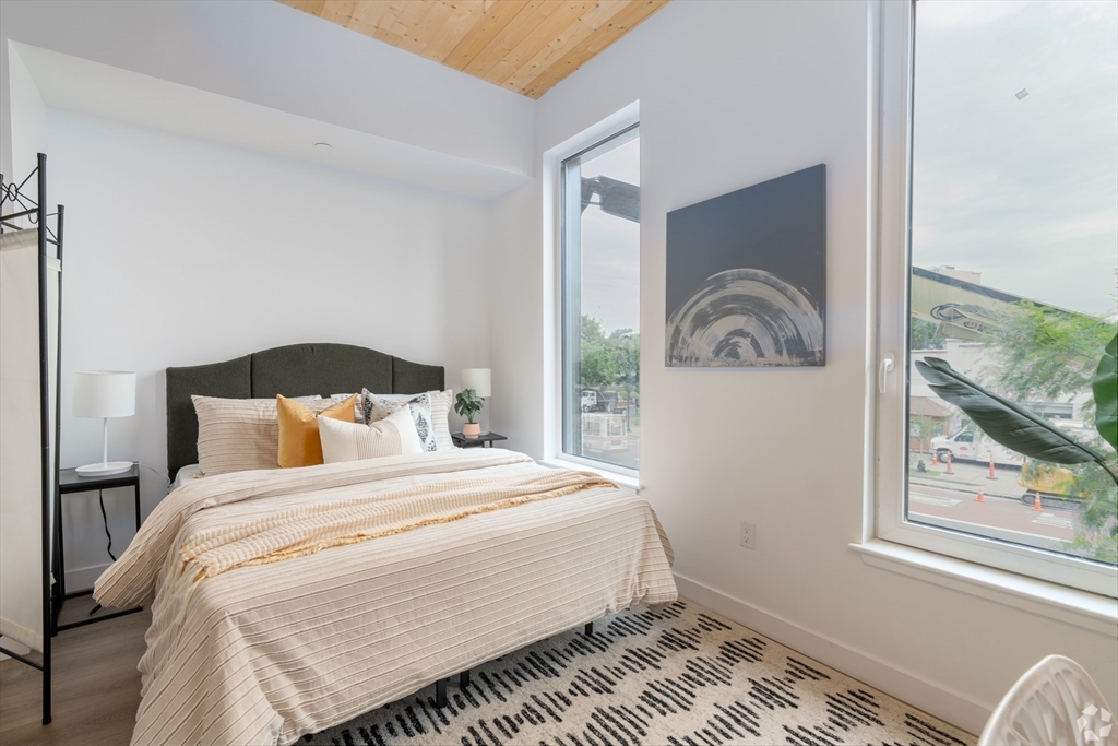 154 Broadway, Unit 409 Somerville, MA 02145 - Photo 5 of 18 a bedroom with a bed and a window