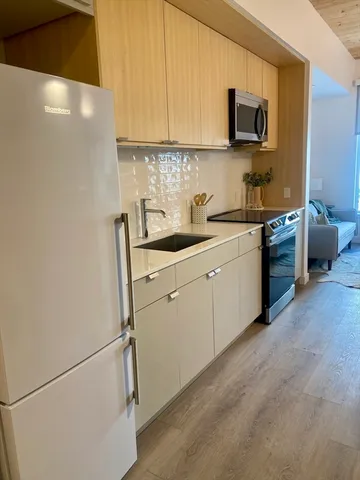 a kitchen with stainless steel appliances granite countertop a sink and a stove top oven