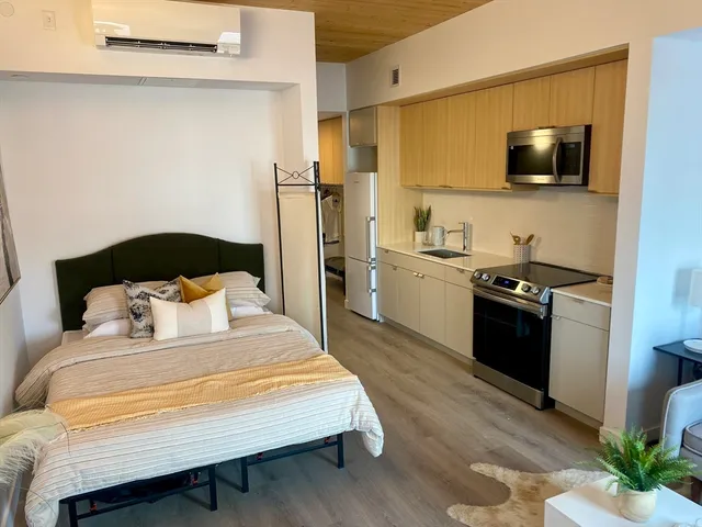 a bedroom with a bed and a television