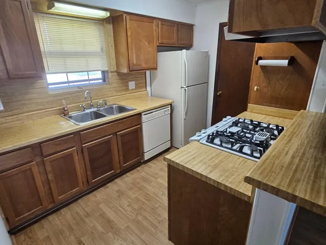 a kitchen with a refrigerator and a sink